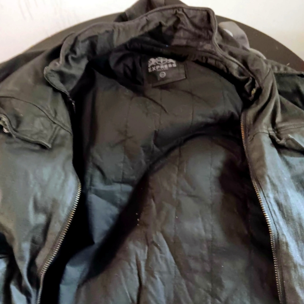 A brand new Guess leather jacket with a hood. It's a XL black leather jacket.